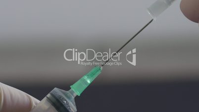 Medical hand putting the cap on hypodermic needle