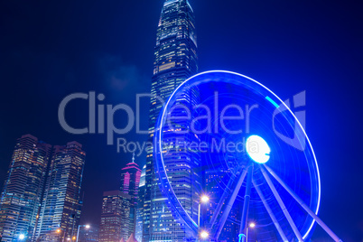 Large Ferris Wheel on the Background of Night Skyscrapers