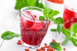 Healthy detox drink with goji berries infused in water with ice, cold refreshing beverage