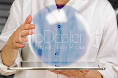 Woman holding tablet pc with glass ball