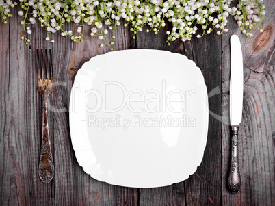 White porcelain plate with iron vintage cutlery