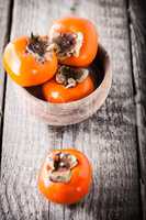 Persimmons on a wooden table