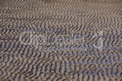 Beach sand waves warm texture pattern background
