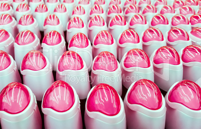 Deodorant, bottles with pink lids in a row.