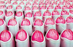 Deodorant, bottles with pink lids in a row.