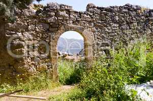 Ruined wall with an arcade door and