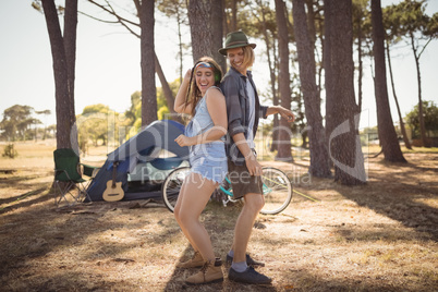 Happy couple dancing on field