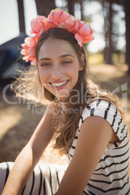 Portrait of smiling woman sitting on field