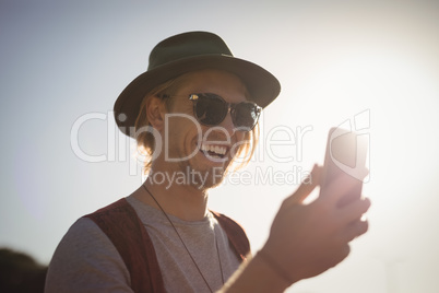 Joyful man using phone
