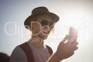 Joyful man using phone