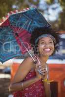 Cheerful woman holding umbrella