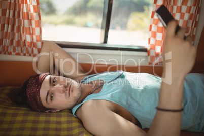 Portrait of man using phone in van
