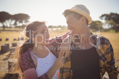 Smiling couple looking at each other while standing together