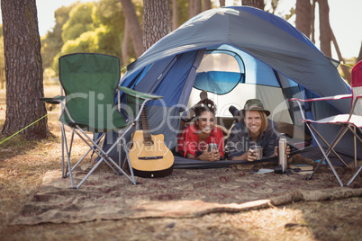 Portrait of couple relaxing in tent