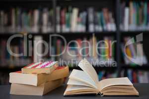 Close up of books on table against shelf