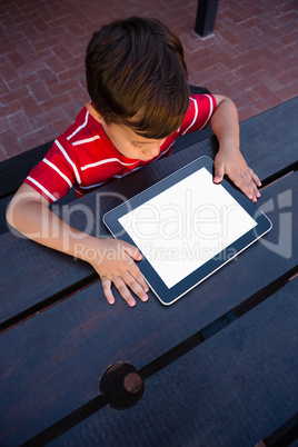 High angle view of boy looking at tablet