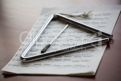 Close up of musical instrument with sheet music on table
