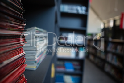 Stack of books on shelf in library