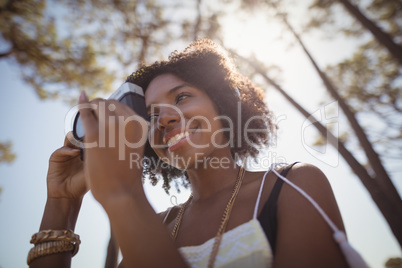 Low angle view of woman photographing