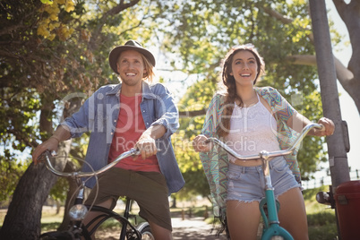 Low angle view of happy couple riding bicycles