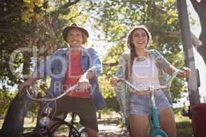 Low angle view of happy couple riding bicycles