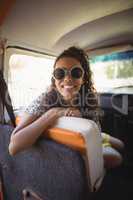 Joyful woman sitting in van
