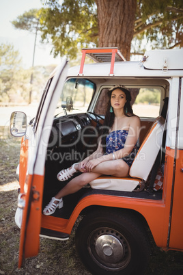 Portrait of young woman sitting in motor home