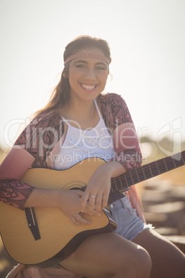 Portrait of smiling woman with guitar
