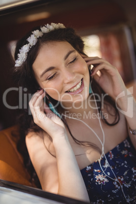 Close up of young woman listening music