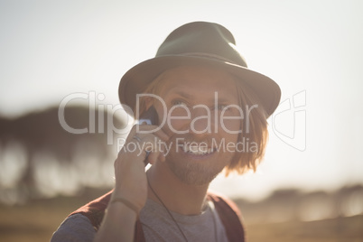 Smiling man talking on mobile phone