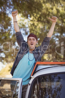 Portrait of man with arms raised in van