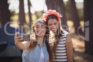 Happy female friends taking selfie