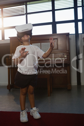 Smiling boy wearing virtual reality simulator while standing at home