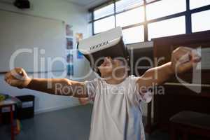 Close up of boy wearing virtual reality with arms raised
