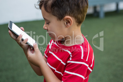 Side view of boy using smart phone