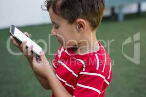 Side view of boy using smart phone