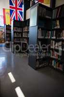 Flags by bookshelf in library