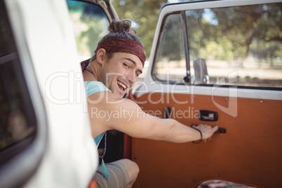 Portrait of man holding van door