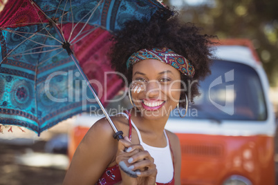 Portrait of happy woman holding umbrella