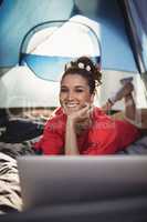 Portrait of happy young woman in tent