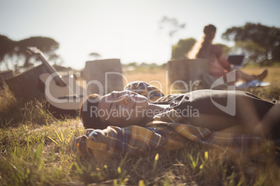 Ypung man resting on grassy field