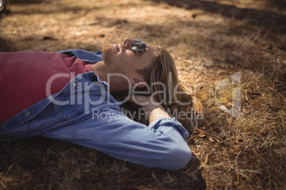 High angle view of man relaxing on grassy field