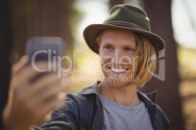 Close up of smiling young man clicking selfie