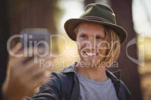 Close up of smiling young man clicking selfie