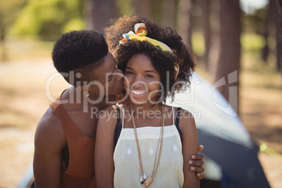 Close up of romantic couple sitting against tent