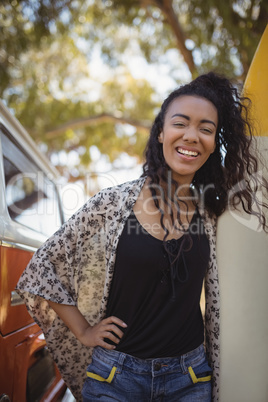 Portrait of cheerful woman with surfboard