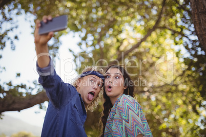 Happy couple making faces while taking selfie