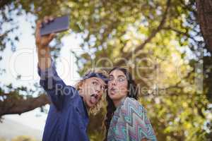 Happy couple making faces while taking selfie
