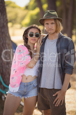 Portrait of confident couple standing on field