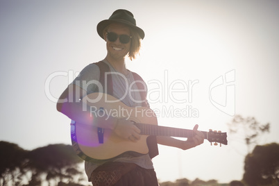 Portrait of smiling man playing guitar